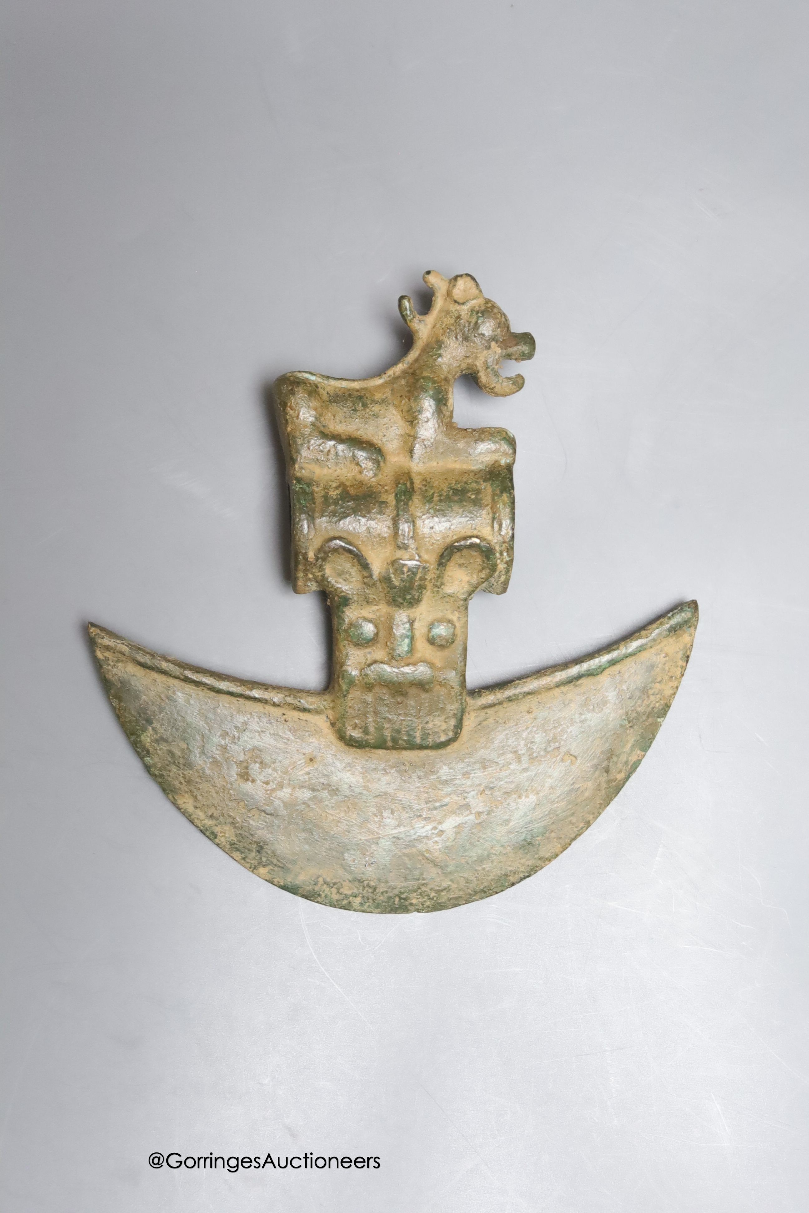 A Luristan style bronze axe head on stand